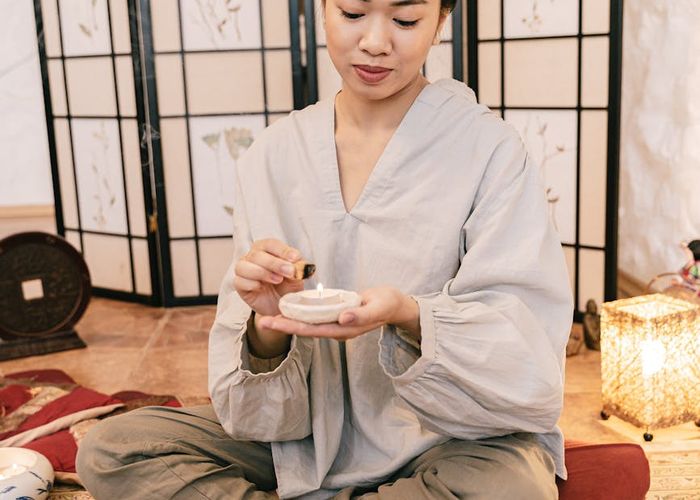 Person meditating in a serene environment, symbolizing inner peace and harmony.